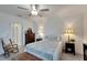 Cozy bedroom with a queen-size bed and rocking chair near ensuite bathroom at 31451 Moniker Mast Ln, San Antonio, FL 33576