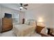 Charming bedroom with a double bed, dresser, and a ceiling fan at 31451 Moniker Mast Ln, San Antonio, FL 33576