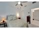Comfortable bedroom with a double bed, ceiling fan, and access to the bathroom at 31451 Moniker Mast Ln, San Antonio, FL 33576