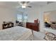 Bright bedroom with a comfortable bed, built-in dresser, and home office space at 31451 Moniker Mast Ln, San Antonio, FL 33576