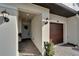 Front entryway with light fixtures and a wood door at 31451 Moniker Mast Ln, San Antonio, FL 33576