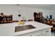 Kitchen island with sink and seating area at 31451 Moniker Mast Ln, San Antonio, FL 33576