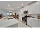 Modern kitchen with white cabinets and island at 31451 Moniker Mast Ln, San Antonio, FL 33576