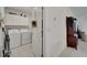 Well-lit laundry room with washer, dryer, and overhead cabinets at 31451 Moniker Mast Ln, San Antonio, FL 33576