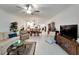 Spacious living room with open floor plan, hardwood floors, and a view into dining area at 31451 Moniker Mast Ln, San Antonio, FL 33576