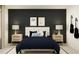 Modern bedroom with dark accent wall, two guitars, and stylish furniture at 36207 Joseph Blake St, Zephyrhills, FL 33541