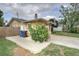 Side of the house showing a brick paver patio area with trash and recycling bins at 4543 20Th N Ave, St Petersburg, FL 33713