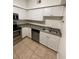White cabinets, stainless steel appliances, and a double sink at 504 S Armenia Ave # 1323, Tampa, FL 33609