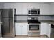 Modern kitchen with stainless steel appliances and white cabinets at 504 S Armenia Ave # 1323, Tampa, FL 33609