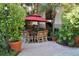 Patio furniture under a red umbrella in a garden setting at 504 S Armenia Ave # 1323, Tampa, FL 33609