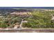 Aerial view of a property with cleared land, trees, and a road at 5250 Little Green Ln, Dade City, FL 33523