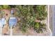 Aerial view of property showcasing the home, lush greenery, detached garage, and proximity to the road at 5250 Little Green Ln, Dade City, FL 33523