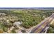 Aerial view of a blue house among trees near a highway at 5250 Little Green Ln, Dade City, FL 33523