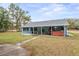 Backyard with a covered patio, hot tub, and grassy area at 5250 Little Green Ln, Dade City, FL 33523