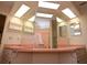 Sunlit bathroom with double sink vanity and large mirrors at 5250 Little Green Ln, Dade City, FL 33523