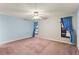 Spacious bedroom with mauve carpet, blue-painted walls, and large windows at 5250 Little Green Ln, Dade City, FL 33523