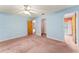 Bedroom with mauve carpet, blue walls, and a walk-in closet at 5250 Little Green Ln, Dade City, FL 33523