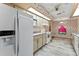 Kitchen featuring white appliances, wood cabinets, and pink countertops at 5250 Little Green Ln, Dade City, FL 33523