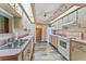 Galley kitchen with wood cabinets, pink countertops, and white appliances at 5250 Little Green Ln, Dade City, FL 33523