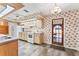 Cozy kitchen with neutral cabinets, linoleum floors, and standard appliances at 5250 Little Green Ln, Dade City, FL 33523