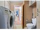 Laundry room with washer, dryer, toilet, and grab bars at 5250 Little Green Ln, Dade City, FL 33523