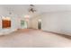 Spacious living room featuring carpet, neutral walls, ceiling fan and decorative lighting at 5250 Little Green Ln, Dade City, FL 33523