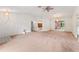 Large living room with neutral carpet, ceiling fans, and access to other rooms at 5250 Little Green Ln, Dade City, FL 33523