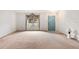 Spacious living room featuring neutral carpet, large window, and an inviting front door at 5250 Little Green Ln, Dade City, FL 33523