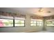 Bright room with ceiling fan and plenty of natural light from large windows at 5250 Little Green Ln, Dade City, FL 33523