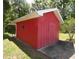 Exterior shot of a bright red storage shed at 5250 Little Green Ln, Dade City, FL 33523