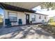 House exterior with carport, landscaping, and seating area at 6019 N Clark Ave, Tampa, FL 33614