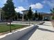 Exterior of community clubhouse, featuring a landscaped entrance and manicured grounds at 661 Allora Ave, Nokomis, FL 34275