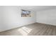 A sun-filled bedroom with a large window and new flooring creating a cozy retreat at 7235 12Th N Ave, St Petersburg, FL 33710