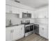Modern kitchen with sleek, white cabinets and stainless steel appliances at 7235 12Th N Ave, St Petersburg, FL 33710