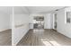 Bright, open living area with modern floors, white walls, and sliding glass doors to the outdoors at 7235 12Th N Ave, St Petersburg, FL 33710