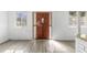 Bright living room with lots of natural light, new flooring, and a view of the entryway at 7235 12Th N Ave, St Petersburg, FL 33710