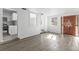 Bright living area leads to the kitchen, featuring modern floors, and white walls at 7235 12Th N Ave, St Petersburg, FL 33710