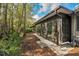 Home exterior showcasing sunroom and wooded view at 873 Lucas Ln, Oldsmar, FL 34677