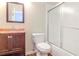 Bathroom with wooden vanity, toilet and shower with sliding door at 8737 Bardmoor Pl # 101, Seminole, FL 33777