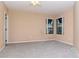 Bright bedroom featuring neutral carpet, ceiling fan, and two windows for plenty of natural light at 8737 Bardmoor Pl # 101, Seminole, FL 33777