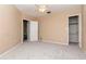 Spacious bedroom with neutral carpet, ceiling fan, and two closets at 8737 Bardmoor Pl # 101, Seminole, FL 33777