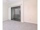 Bedroom featuring neutral walls, carpet flooring and sliding glass doors at 8737 Bardmoor Pl # 101, Seminole, FL 33777