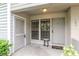 Inviting condo front entrance with 'Welcome to our home' doormat, neutral paint and simple decor at 8737 Bardmoor Pl # 101, Seminole, FL 33777