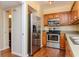 Well-lit kitchen with stainless steel appliances and hardwood flooring, perfect for cooking at 8737 Bardmoor Pl # 101, Seminole, FL 33777