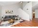 Comfortable living room with vaulted ceilings, modern artwork, and hardwood floors at 8737 Bardmoor Pl # 101, Seminole, FL 33777