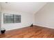 Bright living room with vaulted ceiling, wood flooring, and a large window at 8737 Bardmoor Pl # 101, Seminole, FL 33777