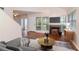 Bright living room with a fireplace, large windows, and hardwood floors at 8737 Bardmoor Pl # 101, Seminole, FL 33777