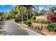 Community entrance with a brick sign amid lush landscaping and palm trees at 9100 Dr Martin Luther King Jr N St # 1706, St Petersburg, FL 33702