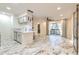 Bright open-concept living area with elegant tile floors, modern lighting, and access to a private balcony at 9100 Dr Martin Luther King Jr N St # 1706, St Petersburg, FL 33702