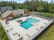 Aerial view of a community pool surrounded by lounge chairs and lush landscaping at 9100 Dr Martin Luther King Jr N St # 1706, St Petersburg, FL 33702